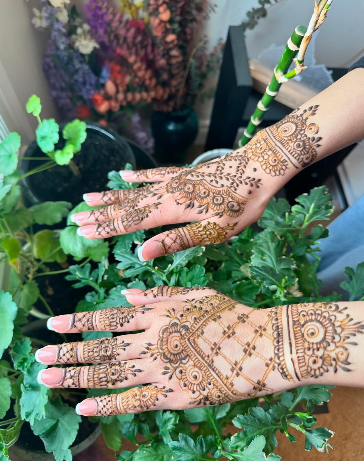 Henna design hands with greenery background Edmonton